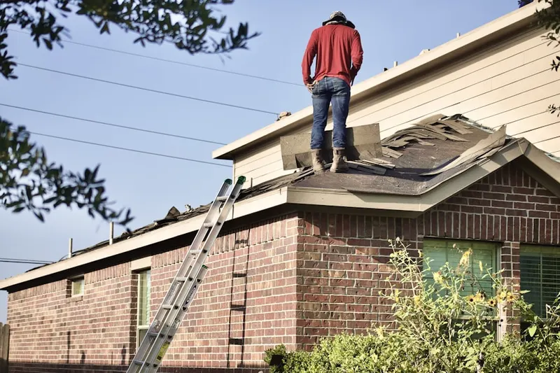 Professional roofer working on a residential roof in Tysons East